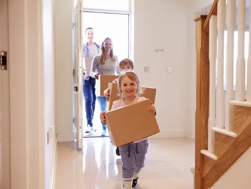 Family moving boxes into new home