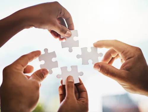 Hands holding puzzle pieces 