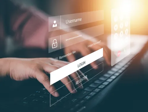 Hands typing on a laptop