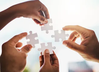Hands holding puzzle pieces 