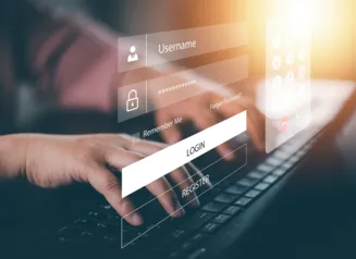 Hands typing on a laptop