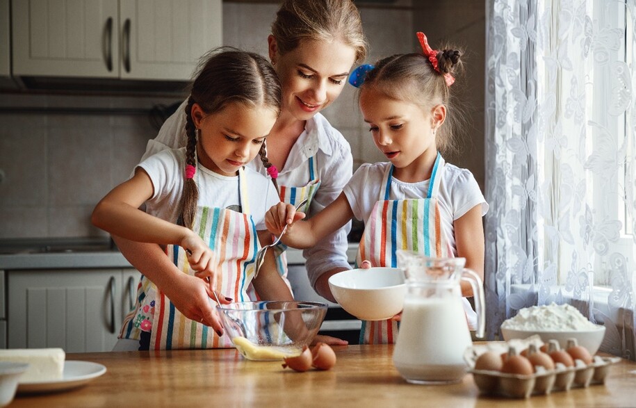 Mother baking with two daughters